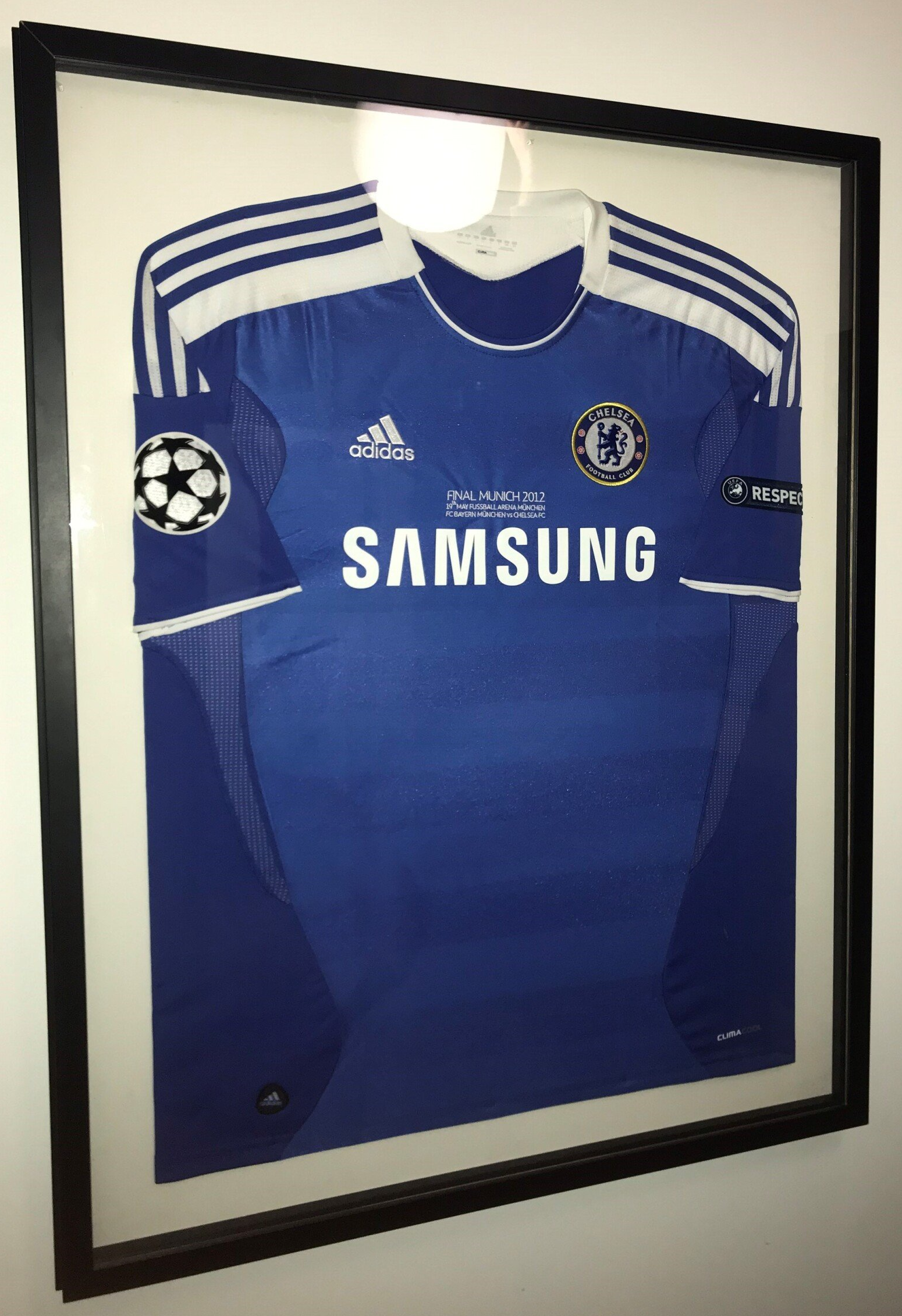 A framed chelsea football shirt